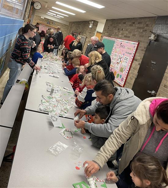 Parents and students making a craft